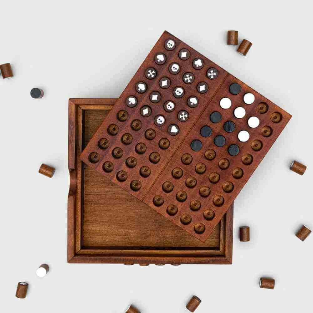 Wooden codebreaker board with symbol pegs and white marker pieces