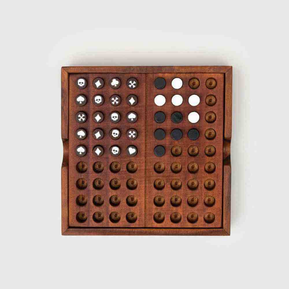 Wooden codebreaker board game with peg grids and white circles