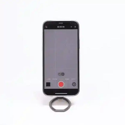 Black magnetic phone holder stand gripping the back of a smartphone