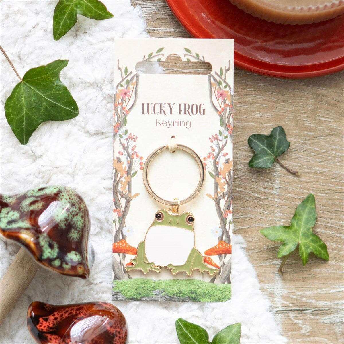 Lucky frog keyring shown on a card with a green cartoon frog charm