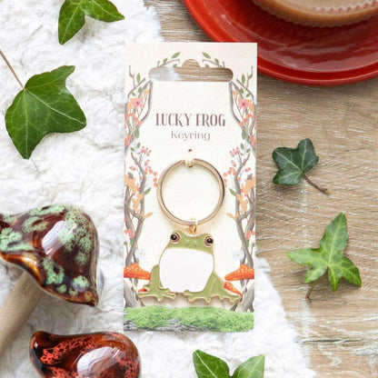 Lucky frog keyring shown on a card with a green cartoon frog charm