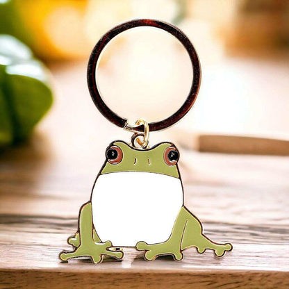 Cartoon frog keyring charm on a dark round ring