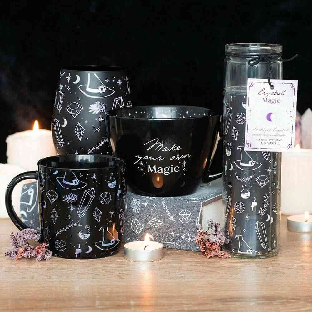 Black ceramic mugs with "Make your own Magic" star and moon design, two cups visible