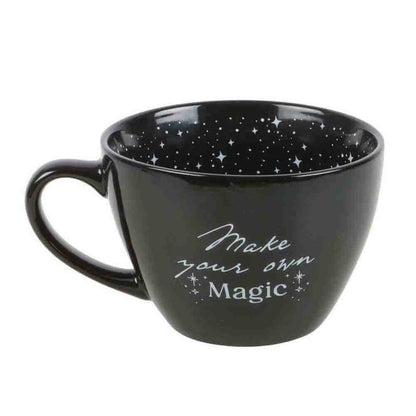 Black ceramic mug with handle, star and moon pattern, "Make your own Magic" text
