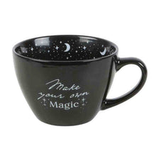 Black ceramic mug with crescent moons and stars, "Make your own Magic" on front