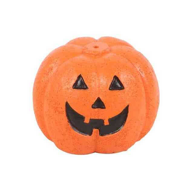 Orange jack-o'-lantern incense stick holder with triangle eyes and smile