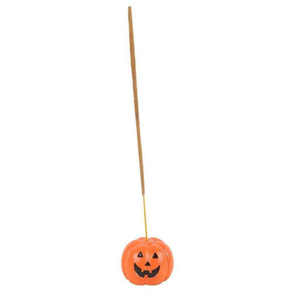 Orange pumpkin incense stick holder at end of incense stick