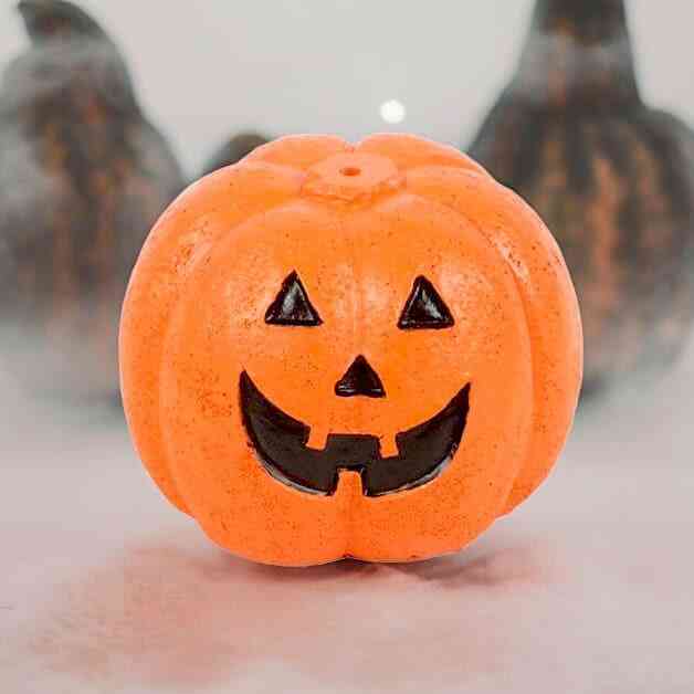 Orange jack-o'-lantern incense stick holder, smooth carved face