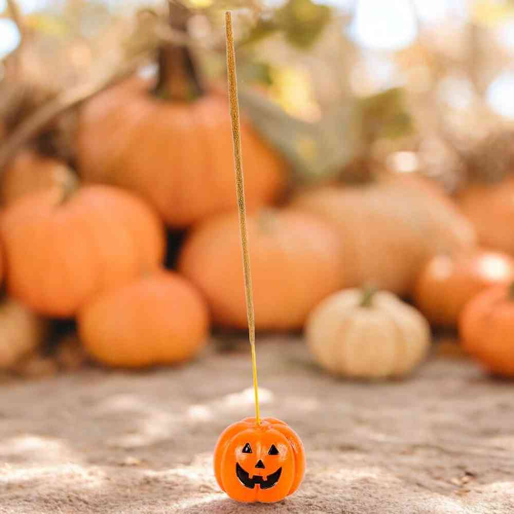 Small pumpkin incense stick holder with jack-o'-lantern face