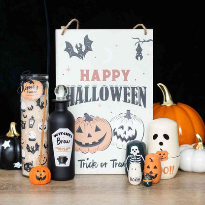 Orange pumpkin incense stick holder among Halloween decorations