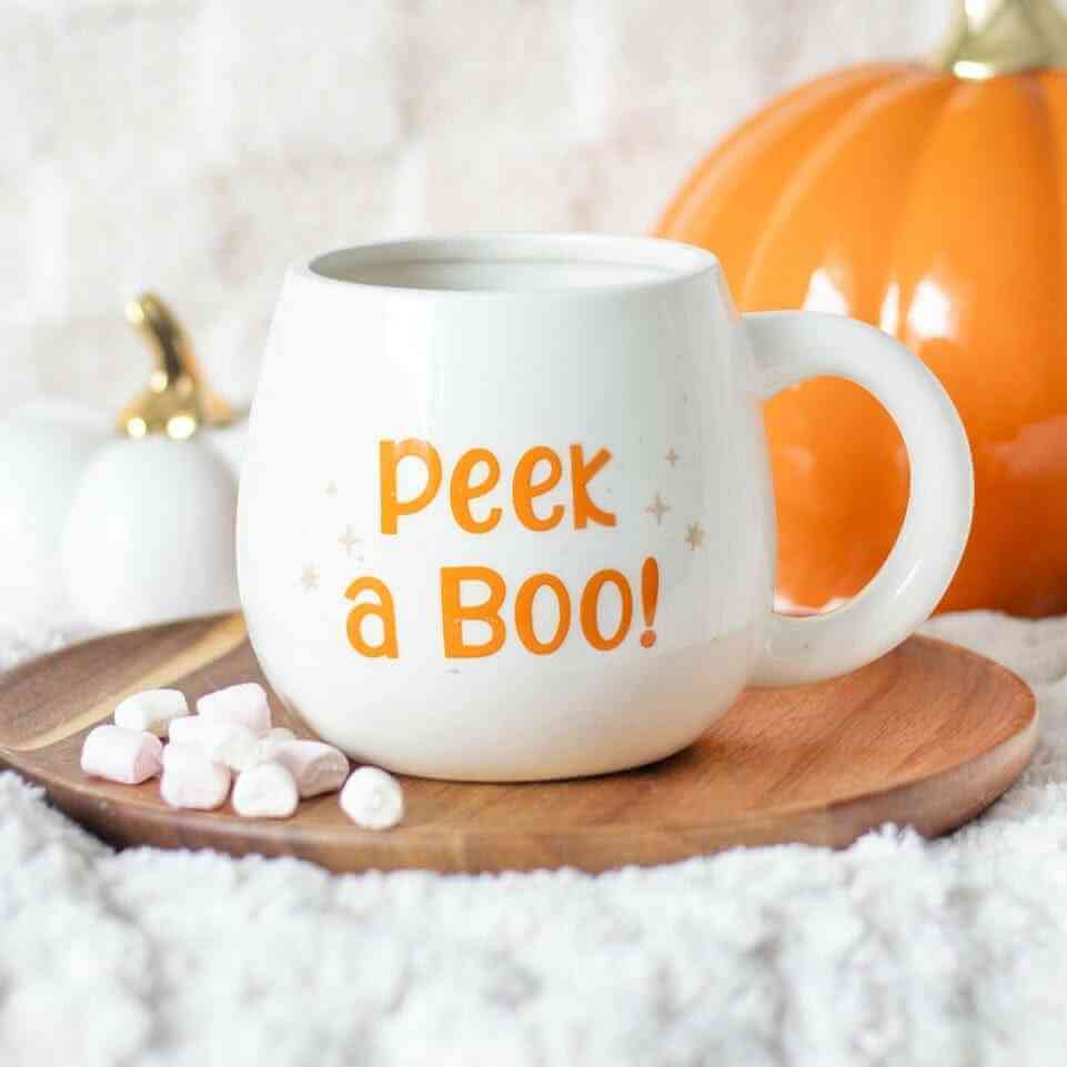 White rounded Halloween mug with orange “Peek a BOO!” text and side handle