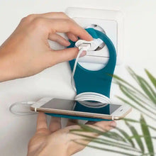 Phone holder with cable tidy, teal backing and white cable, holding a smartphone