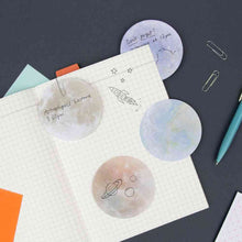 Planet sticky notes with multiple circular moon planet sheets and handwritten page