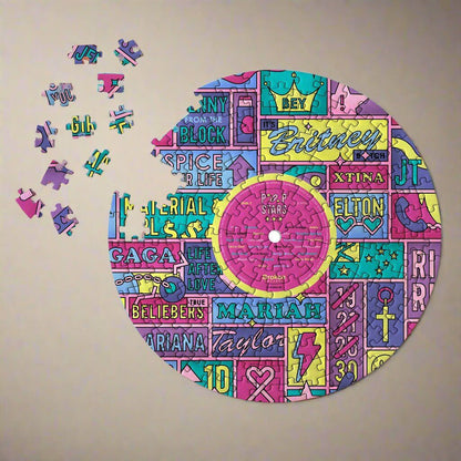 LP-shaped jigsaw puzzle showing colorful pop-star artwork with a few loose pieces