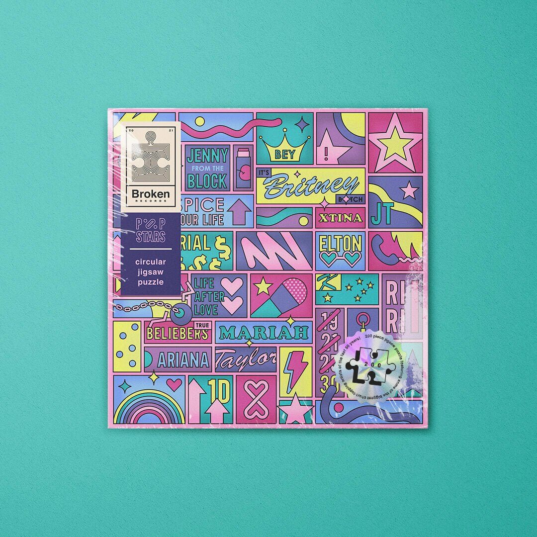 LP-shaped jigsaw puzzle box featuring colorful pop-star name and graphic collage