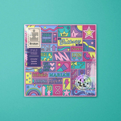 LP-shaped jigsaw puzzle box featuring colorful pop-star name and graphic collage