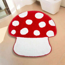 Red mushroom bathroom mat with white polka-dot cap and tufted white stem, oval shape
