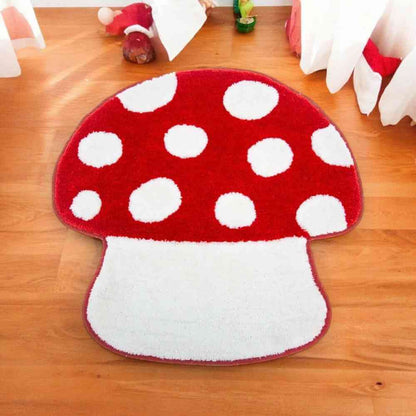 Red mushroom bathroom mat with white polka-dot cap and tufted white stem, on the floor