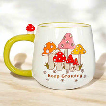 Garden mushroom mug, 3/4 view: white with green handle and 'Keep Growing' mushroom design