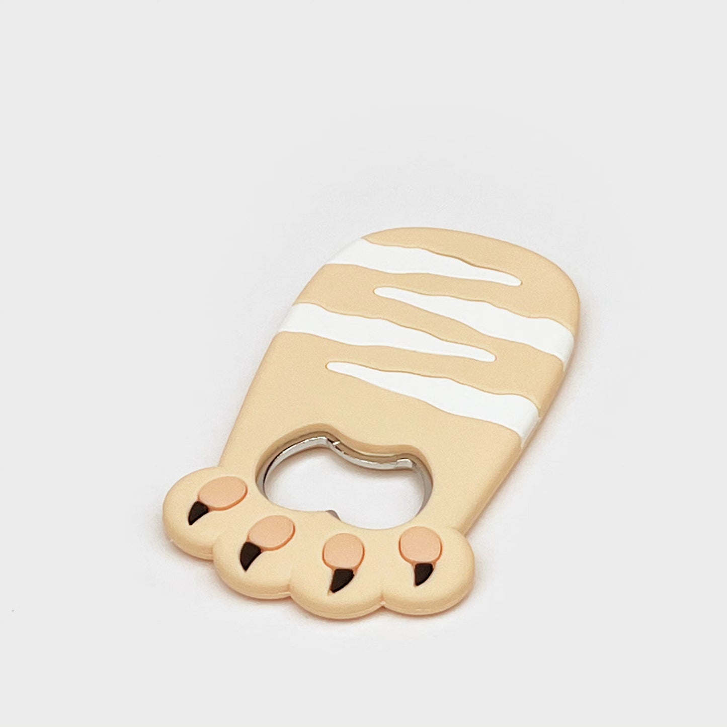 Cat bottle opener magnet close-up with a round bottle-cap opening and three paw pads.