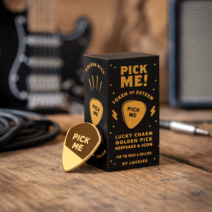 Gold-plated guitar pick charm with “Pick Me” text, leaning in gift box set.