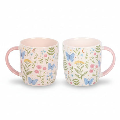 Pair of floral print ceramic mugs, white with colorful leaves and butterflies, pink handles