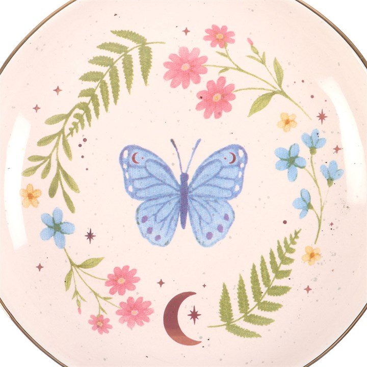 Close-up butterfly trinket dish with pink and green floral border, moon detail