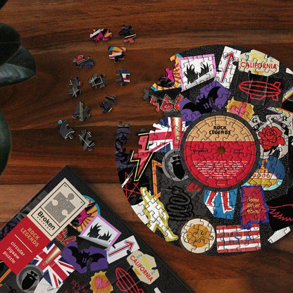 Circular rock jigsaw puzzle with loose pieces and partially assembled center