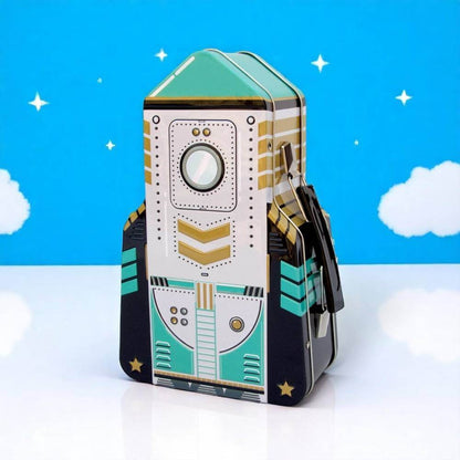 Rocket-shaped lunch box with teal/white space-rocket design and black side straps.