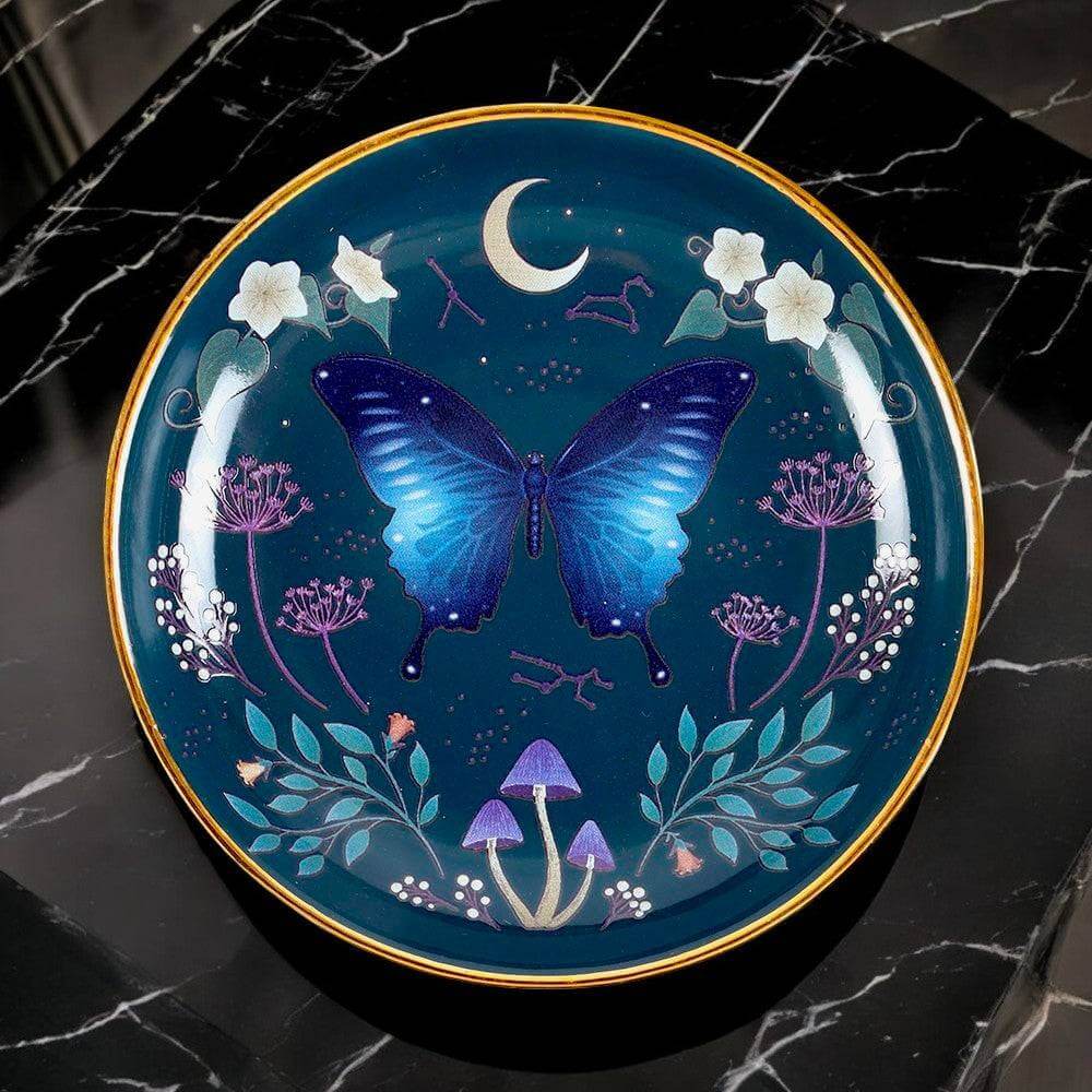 Round trinket dish with blue moth and moon motif on dark blue, gold rim