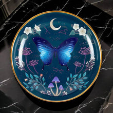 Round trinket dish with blue moth and moon motif on dark blue, gold rim