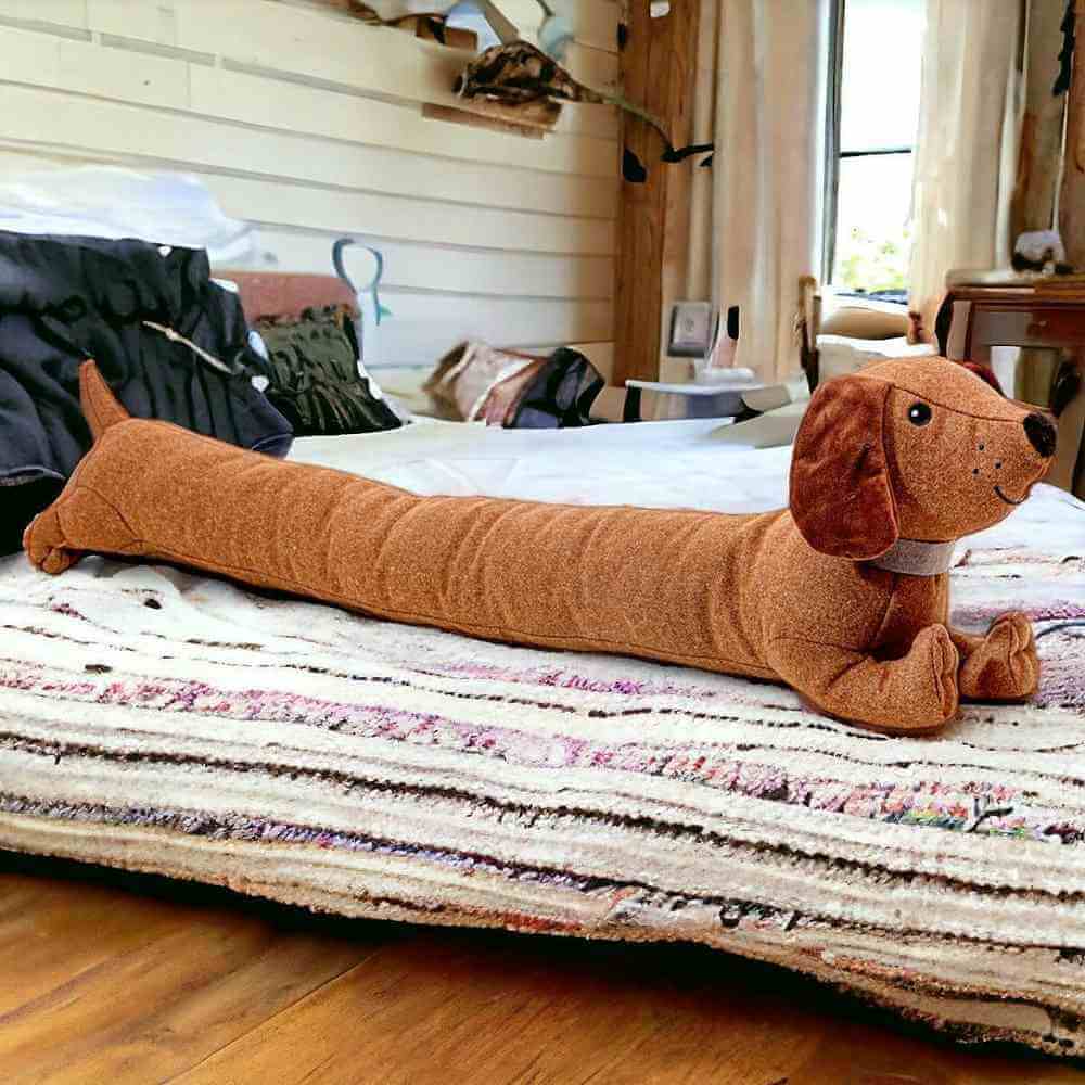 Dachshund draft excluder plush, long orange-brown dog shape with head at right