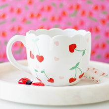 White scalloped mug with red and pink hearts and green cherry stem pattern