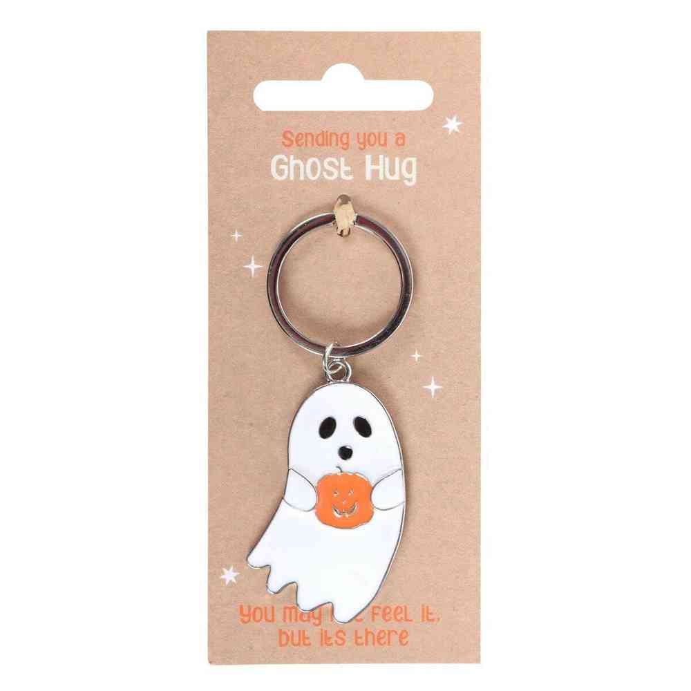 Ghost hug keyring with white ghost charm holding orange pumpkin-shaped heart on card