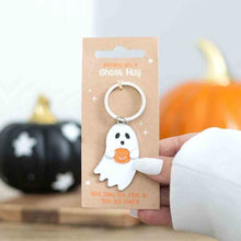 Ghost hug keyring with white ghost charm holding orange pumpkin-shaped heart