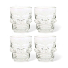 Set of 4 clear glass skull shot glasses, front view with etched skull faces