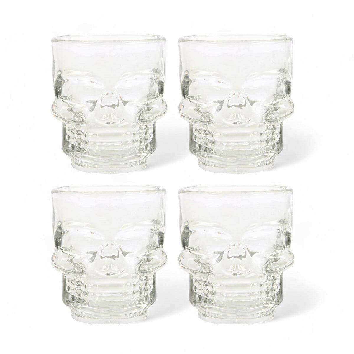 Set of 4 clear skull shot glasses, top view showing etched skull face designs