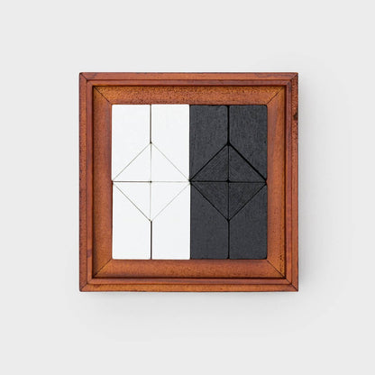 Square wooden puzzle frame with white and dark tangram pieces