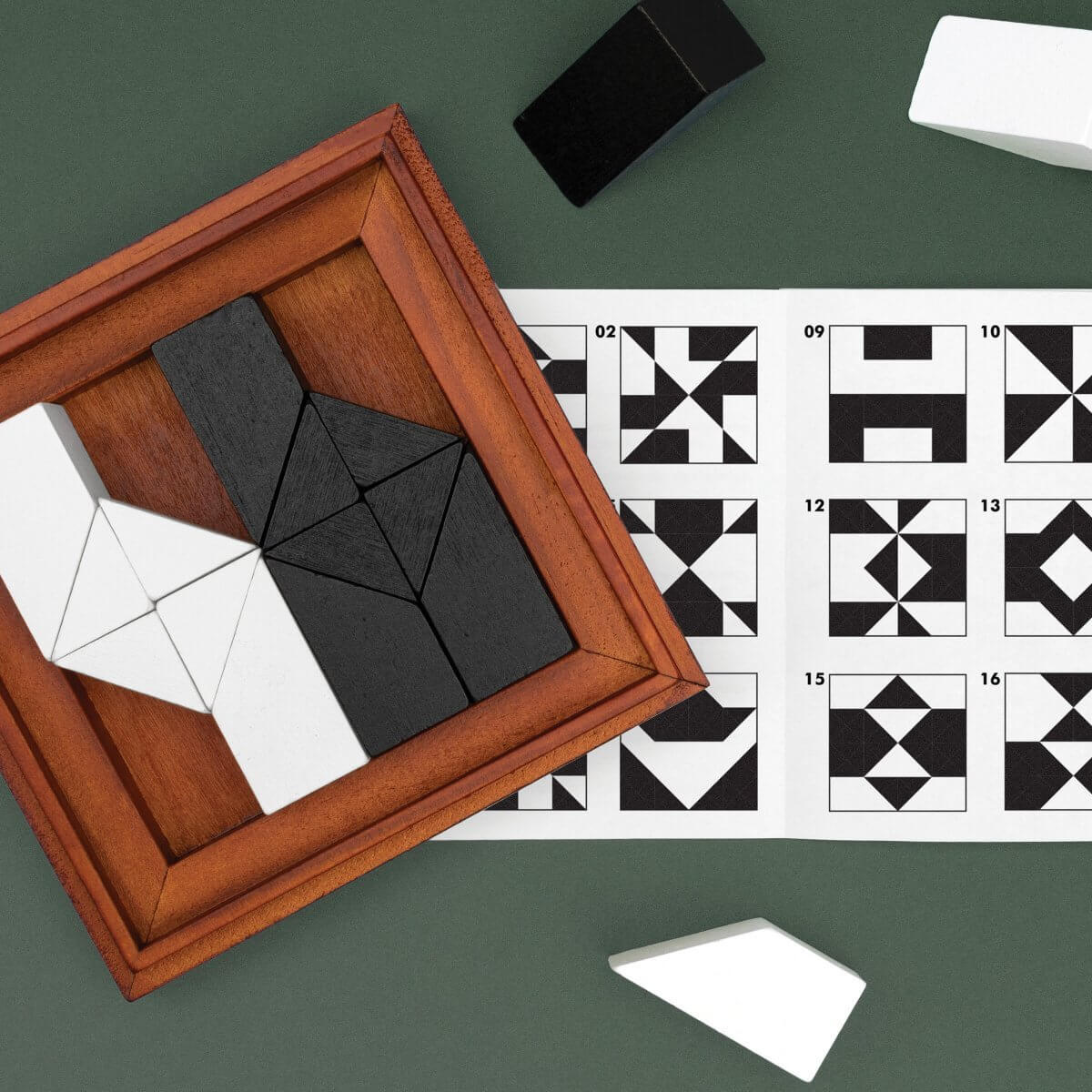 Framed wooden tangram puzzle beside numbered pattern challenge cards