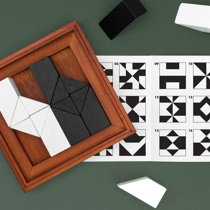 Framed wooden tangram puzzle beside numbered pattern challenge cards