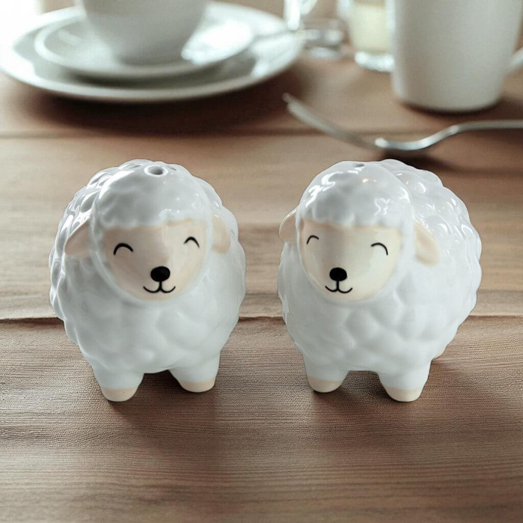 Sheep-shaped ceramic condiment shakers, gray and cream sheep figures with facial details