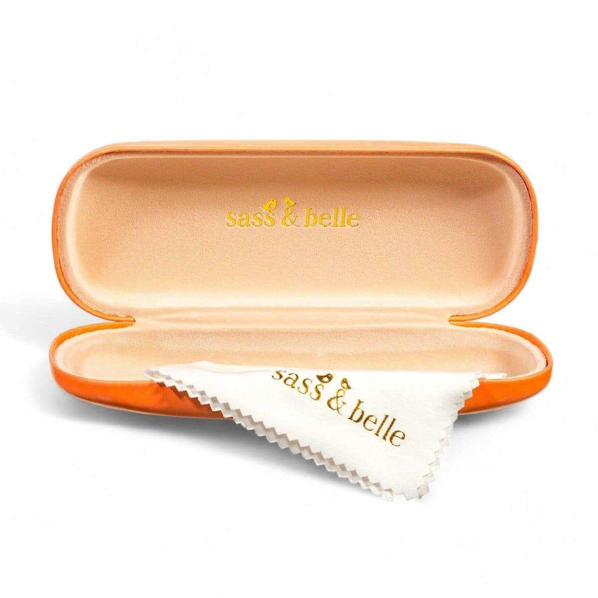 Orange glasses case open with soft lining and folded white cleaning cloth inside.