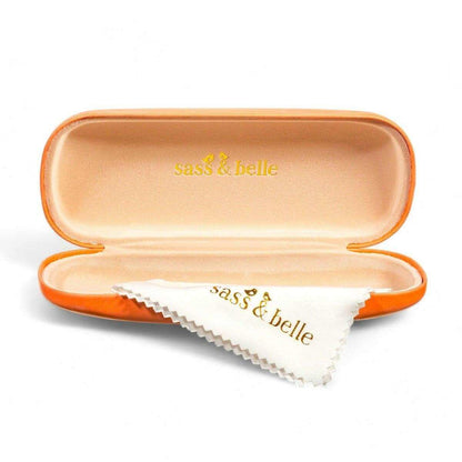 Orange glasses case open with soft lining and folded white cleaning cloth inside.