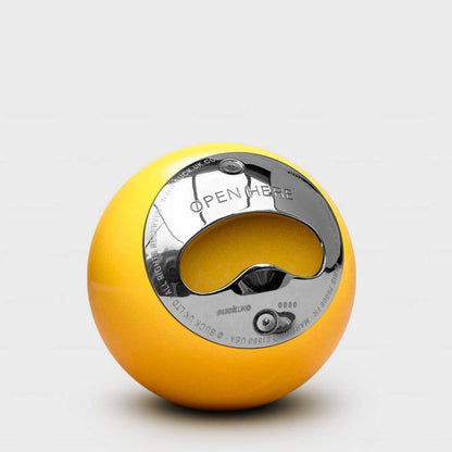 Yellow pool ball bottle opener with circular OPEN HERE metal insert
