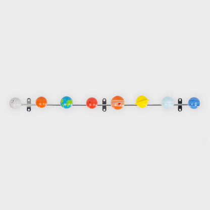 Solar system coat rack with colorful wood planet hooks spaced on a metal bar