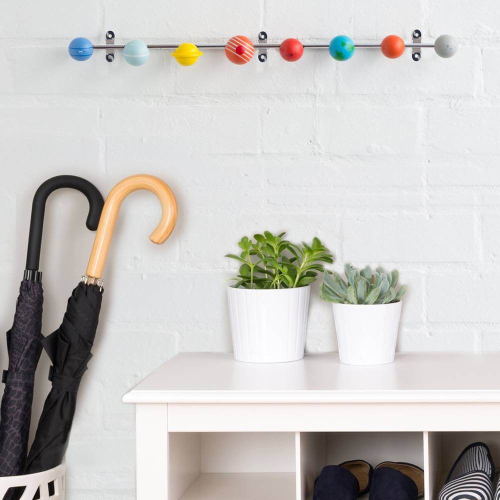 Solar system coat rack with colorful wooden planet hooks along a metal rail