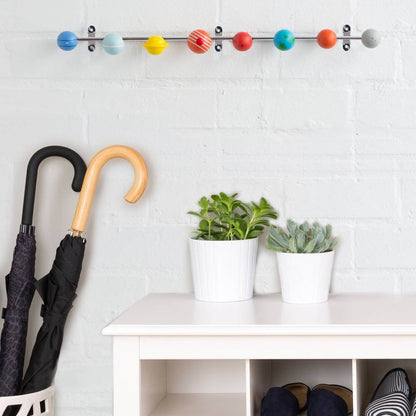 Solar system coat rack with colorful wooden planet hooks along a metal rail