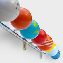 Metal coat hook with wooden planet ornaments in orange, blue, red, and striped colors
