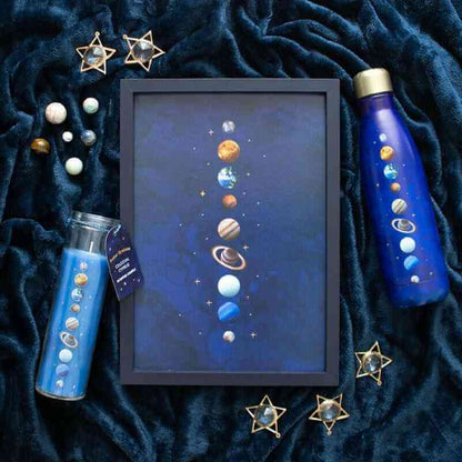 Solar-system metal water bottles with gold caps on dark fabric