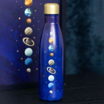Close-up of purple metal water bottle with gold cap and solar-system planets graphic
